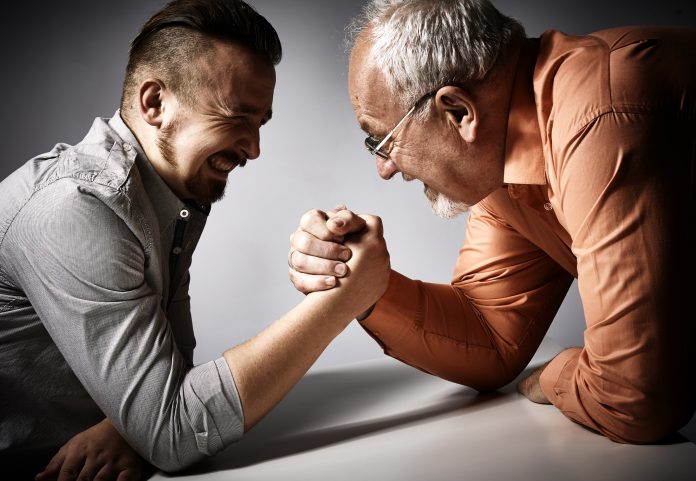 Two men arm wrestling competition.