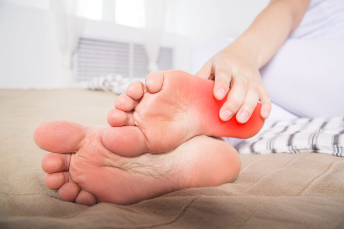 Woman's leg hurts, pain in the heel, massage of female feet